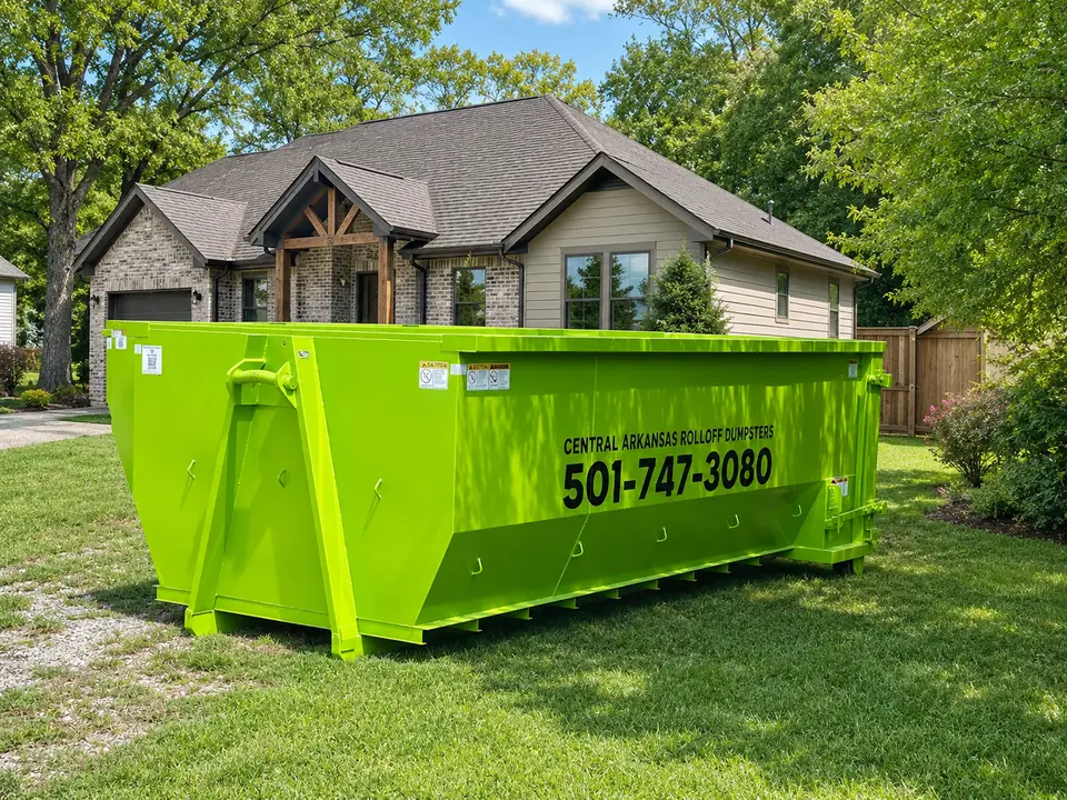 Roll-off dumpster placed on a residential driveway for a home cleanout